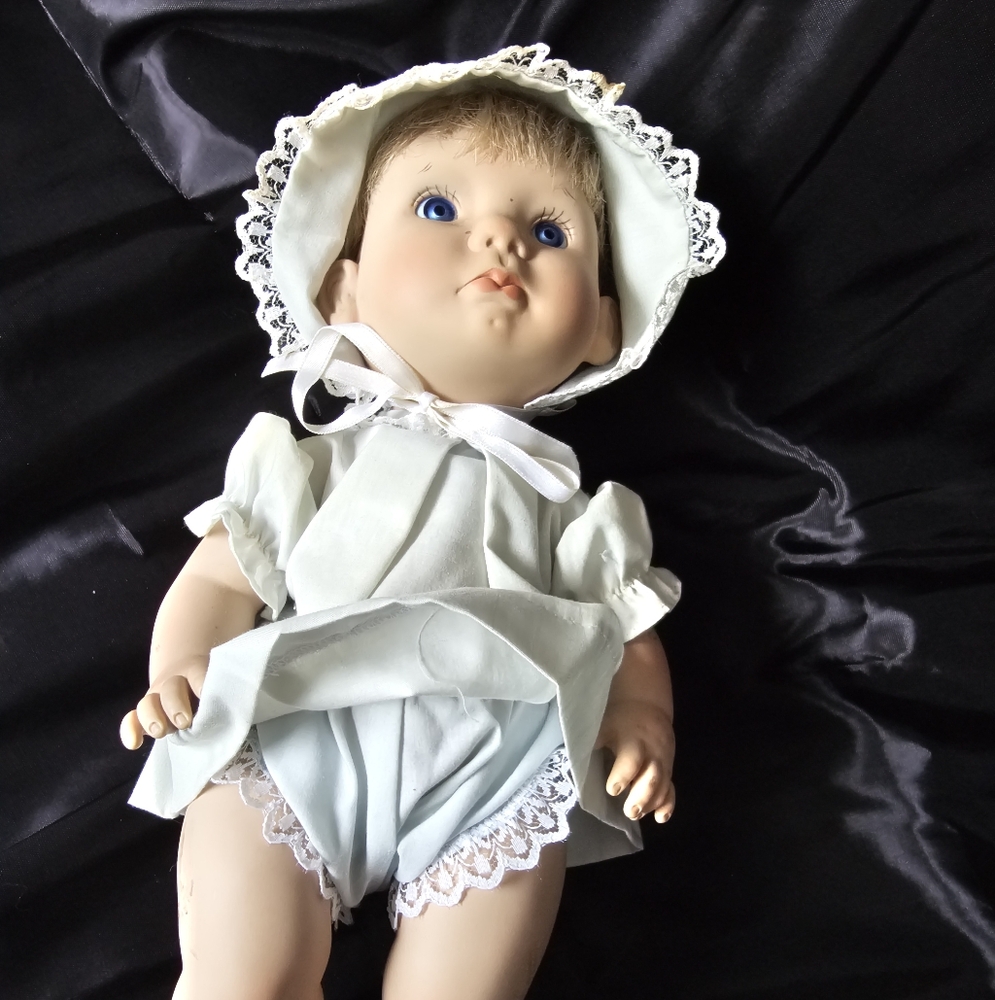 Adorable Baby Doll with Blue Eyes and White Outfit